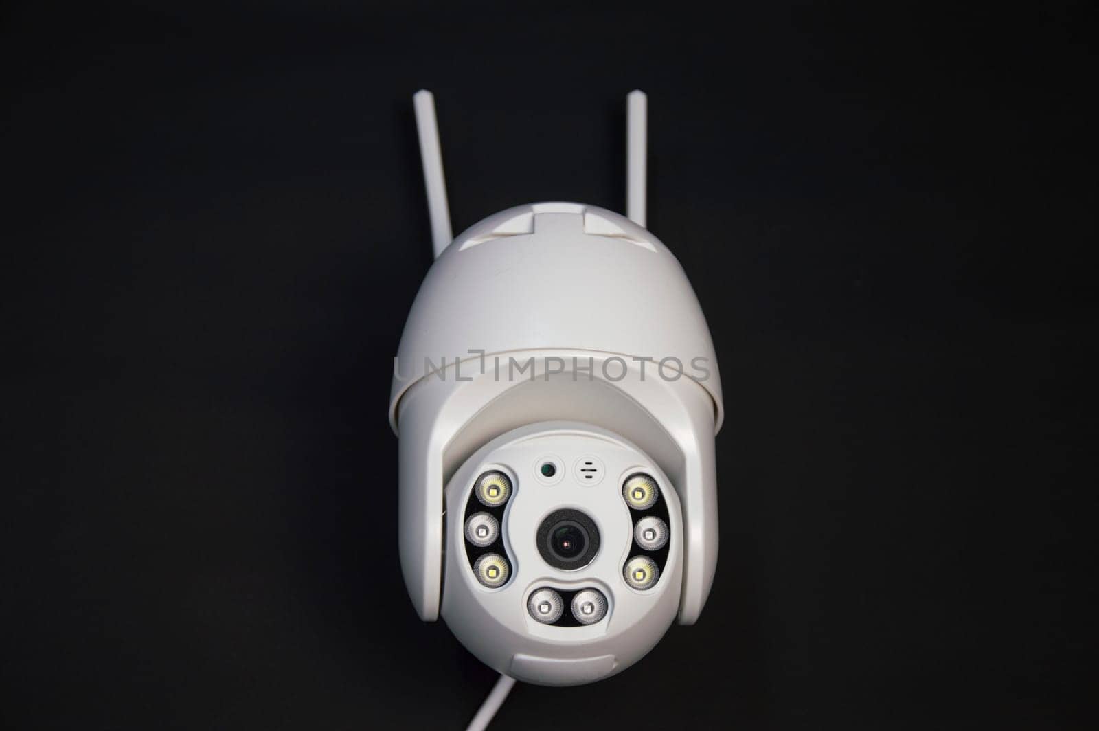 White IP camera over a black background