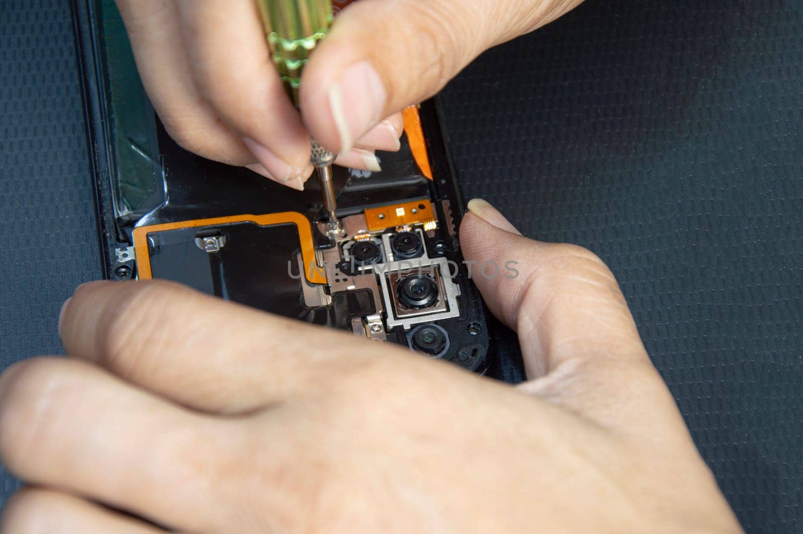 top view, mechanic repairing smartphone by boonruen