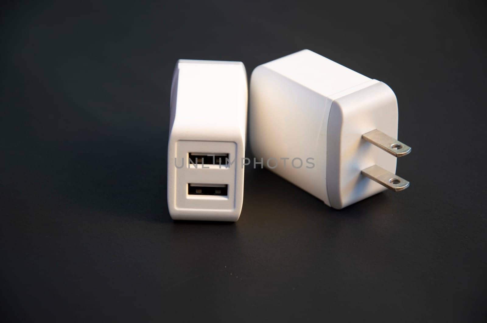 USB charger, white, 2-port type, placed on a black background
