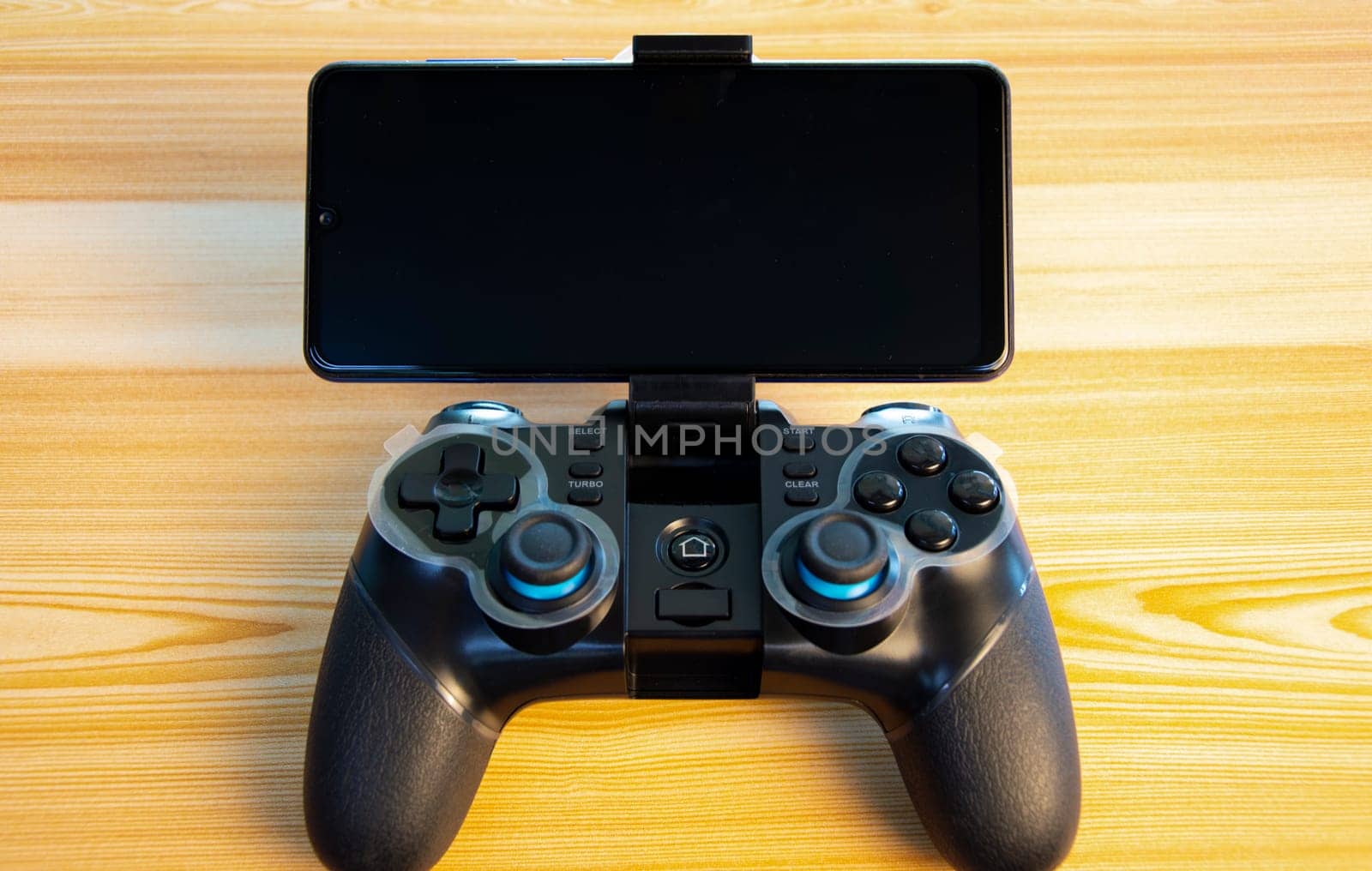 front view of joystick placed on wooden floor by boonruen