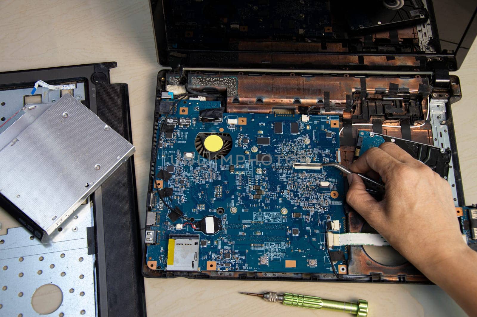 top view, mechanic repairing laptop computer by boonruen