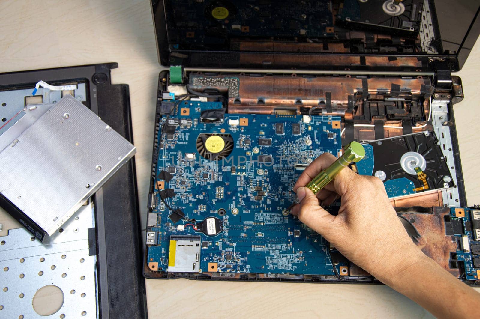 top view mechanic repairing computer notebook, harddisk, cpu