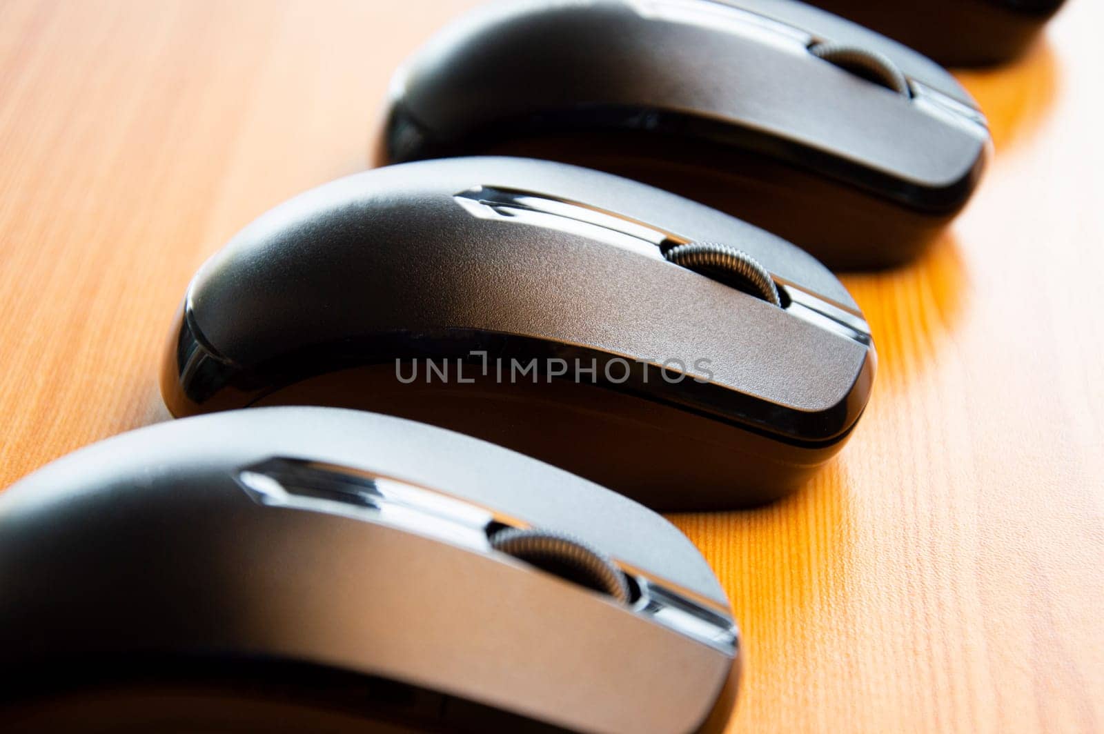 Black wireless mouse placed on wooden floor