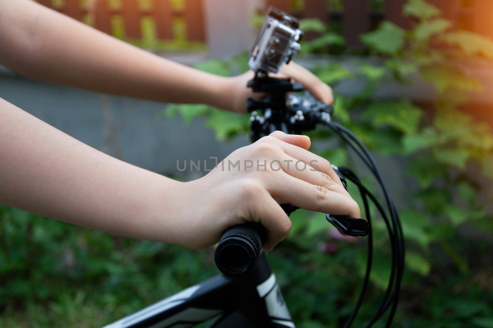 Woman's hand holding the handlebars of a mountain bike by boonruen