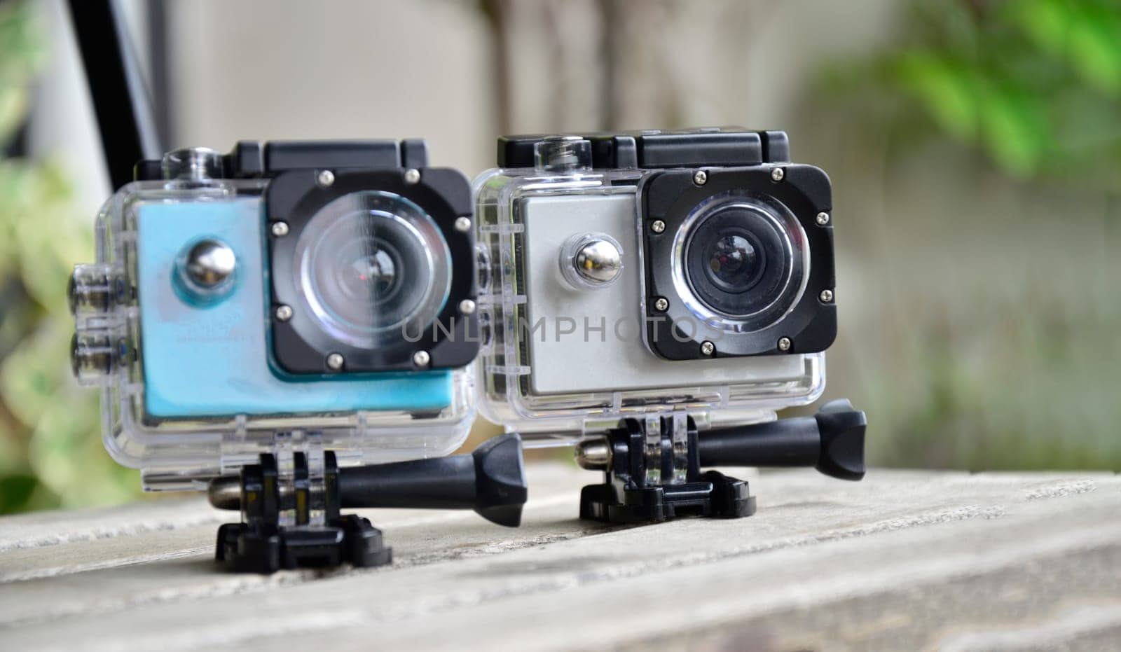 2 action cams placed on the floor, waterproof and dustproof by boonruen