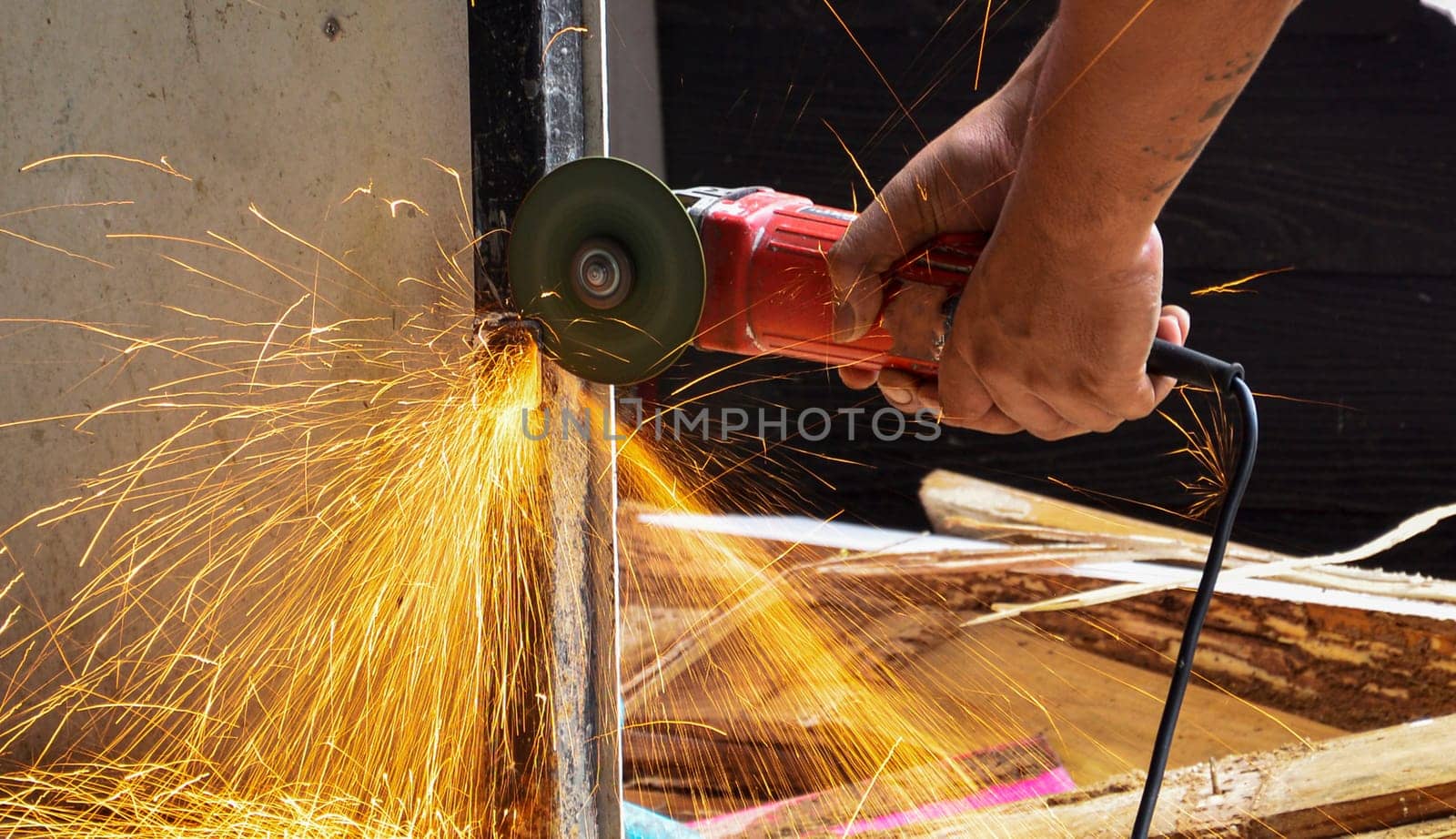 A mechanic was using a grinder, and many sparks appeared.
