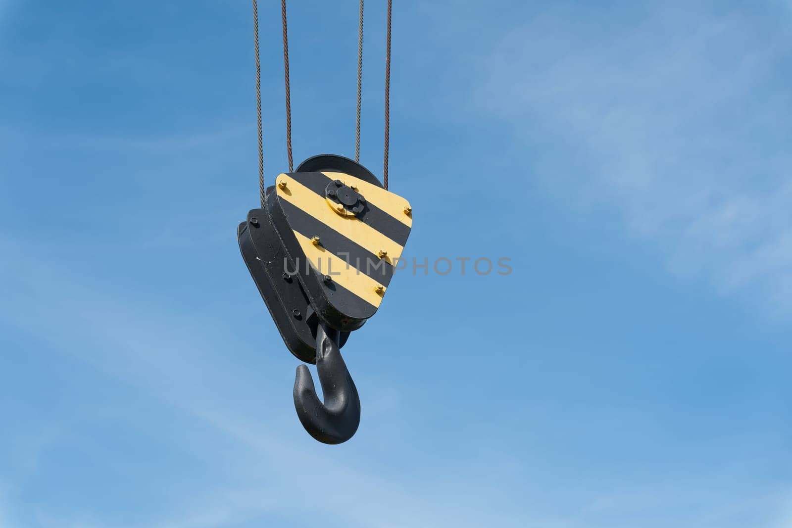 Crane hook of a historic crane in the former commercial port in Magdeburg under a blue sky