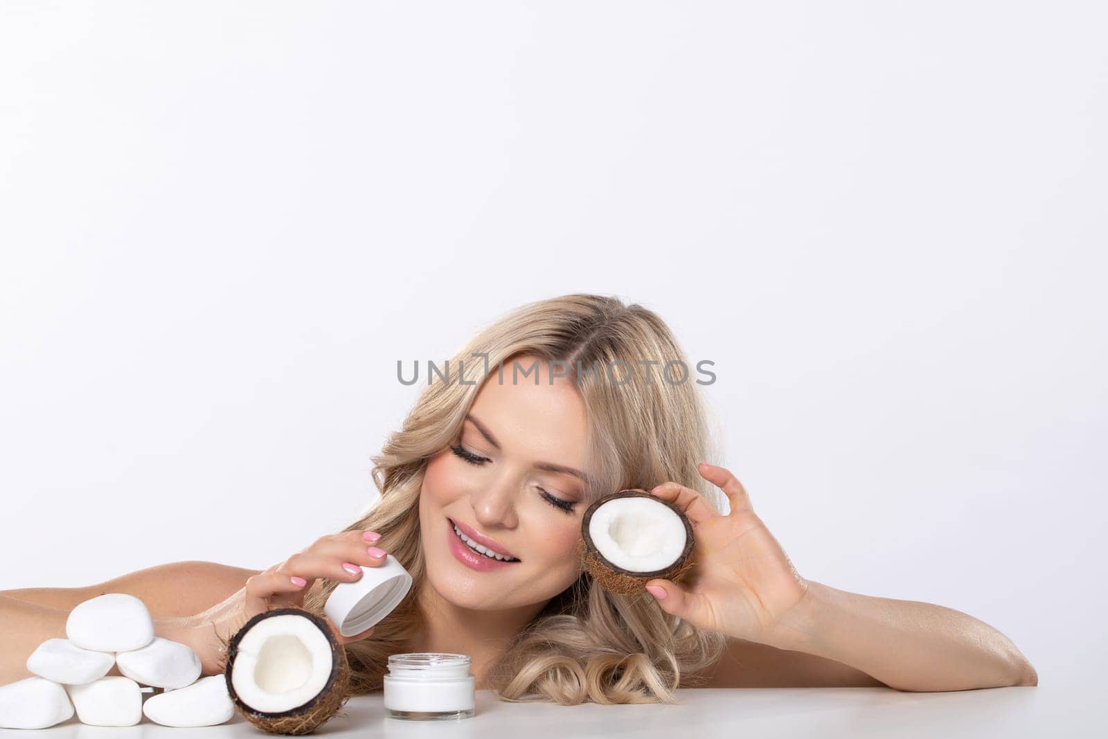 A joyful woman enthusiastically explores various skincare jars, showcasing beauty, vitality, and selfcare routines