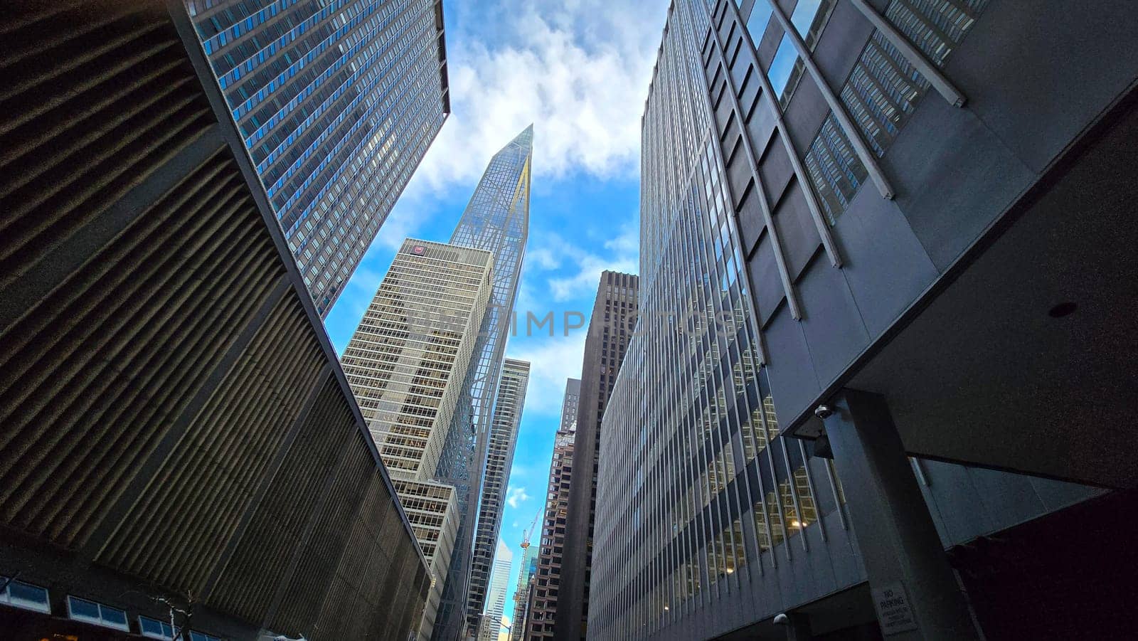 Modern look of a big metropolitan city with illuminated skyscrapers and classic architecture under a clear blue sky. Urban hustle and warm lighting create a vibrant and captivating cityscape. good for multimedia background