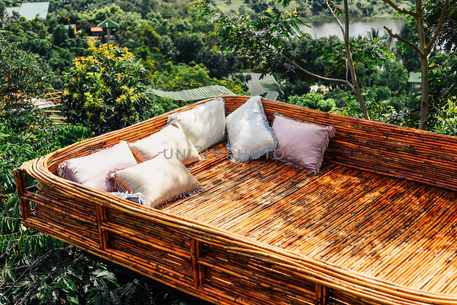 Creative objects in Vietnam wooden bed with cozy pillows against vietnamese landscape of Da Lat city