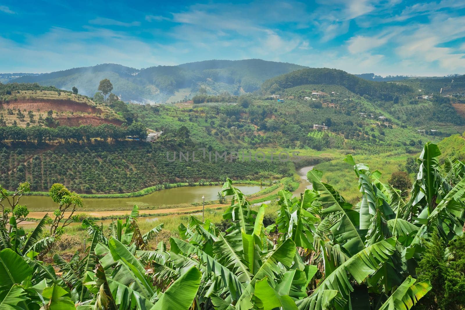 Hills and plantations with steam and clouds of Da Lat city in Vietnam