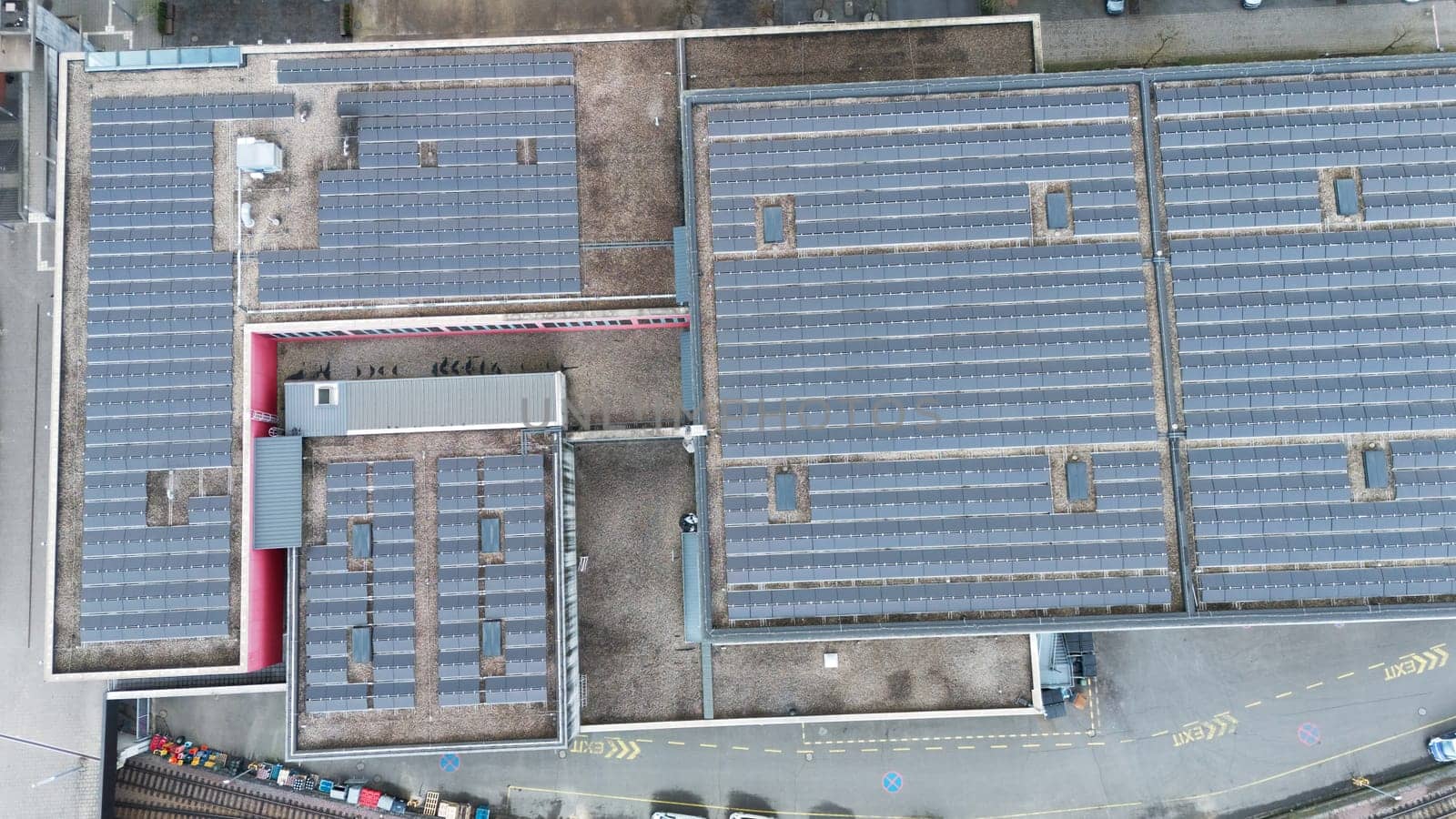 Top-down aerial view of large-scale solar panel installations on industrial rooftops in Esch-sur-Alzette, Luxembourg, highlighting renewable energy and sustainable infrastructure development.