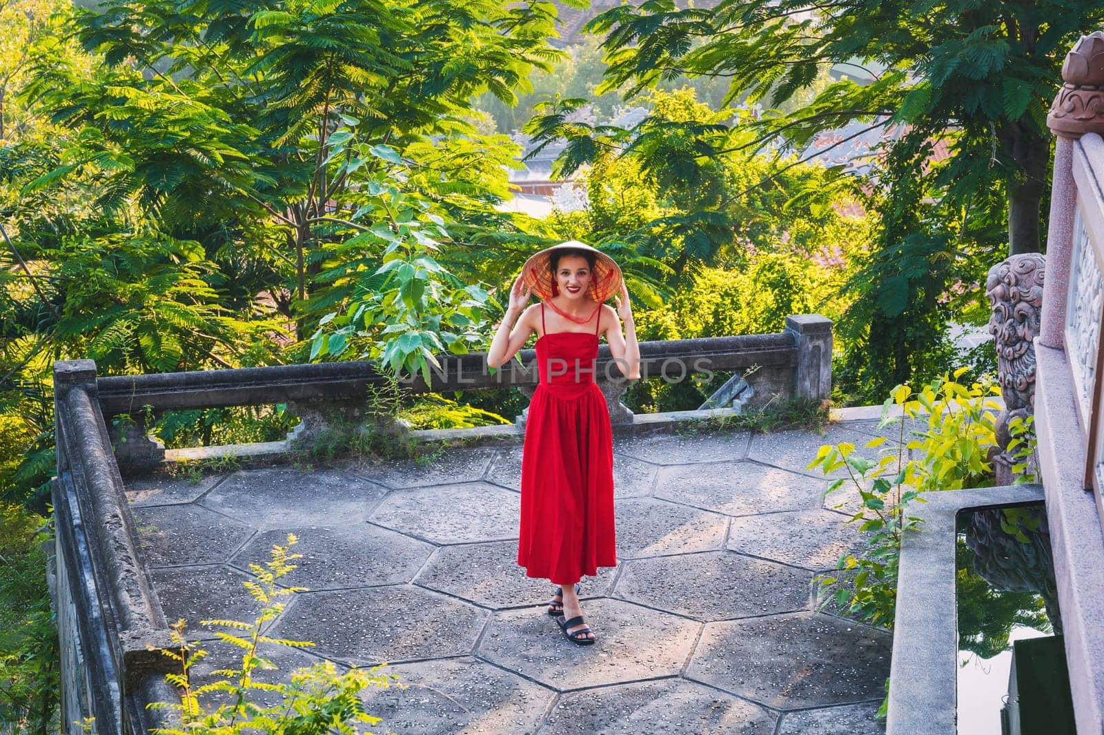 happy tourist woman in Non La hat in Vietnam on a trip to Asia