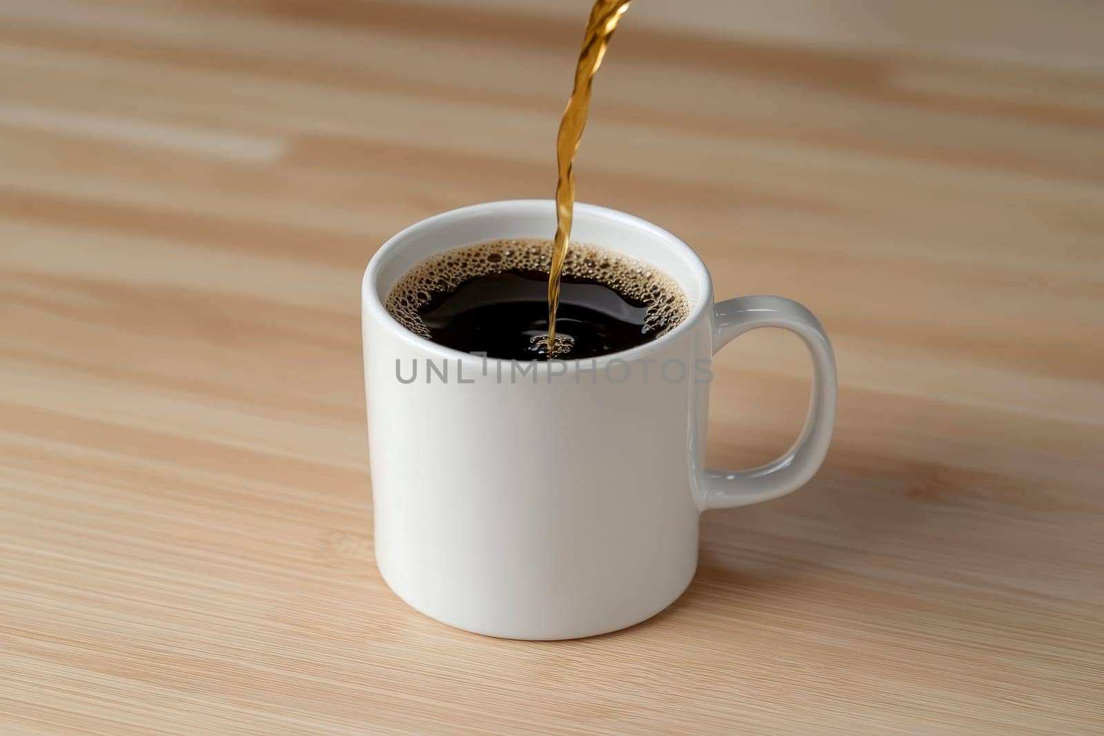 Close-up of hot black coffee being poured into a white cup on a wooden surface..
