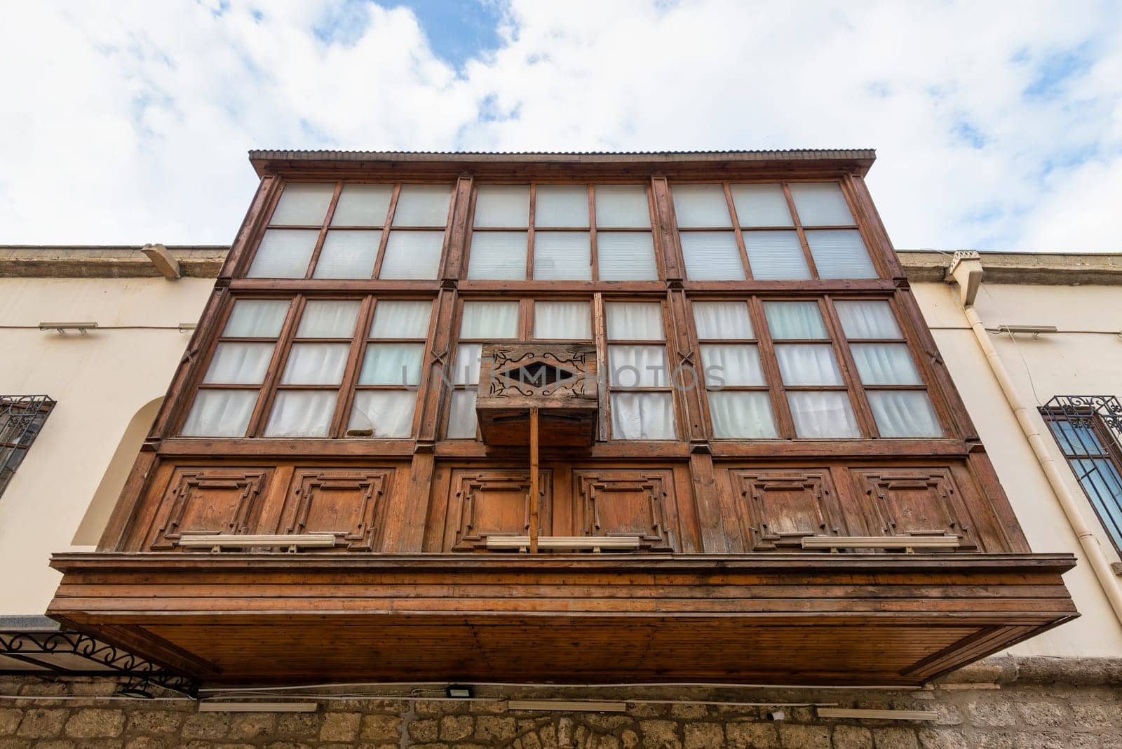Amidst the winding streets of Icherisheher, traditional wooden balconies showcase the rich cultural heritage of Baku, Azerbaijan. The intricate details of this historic architecture are captivating