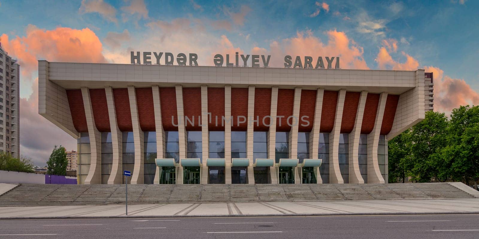 The Heydar Aliyev Palace in Baku, Azerbaijan combines Soviet modernist and Azerbaijani architectural styles, embodying the city's rich cultural heritage through its imposing facade and grand staircase