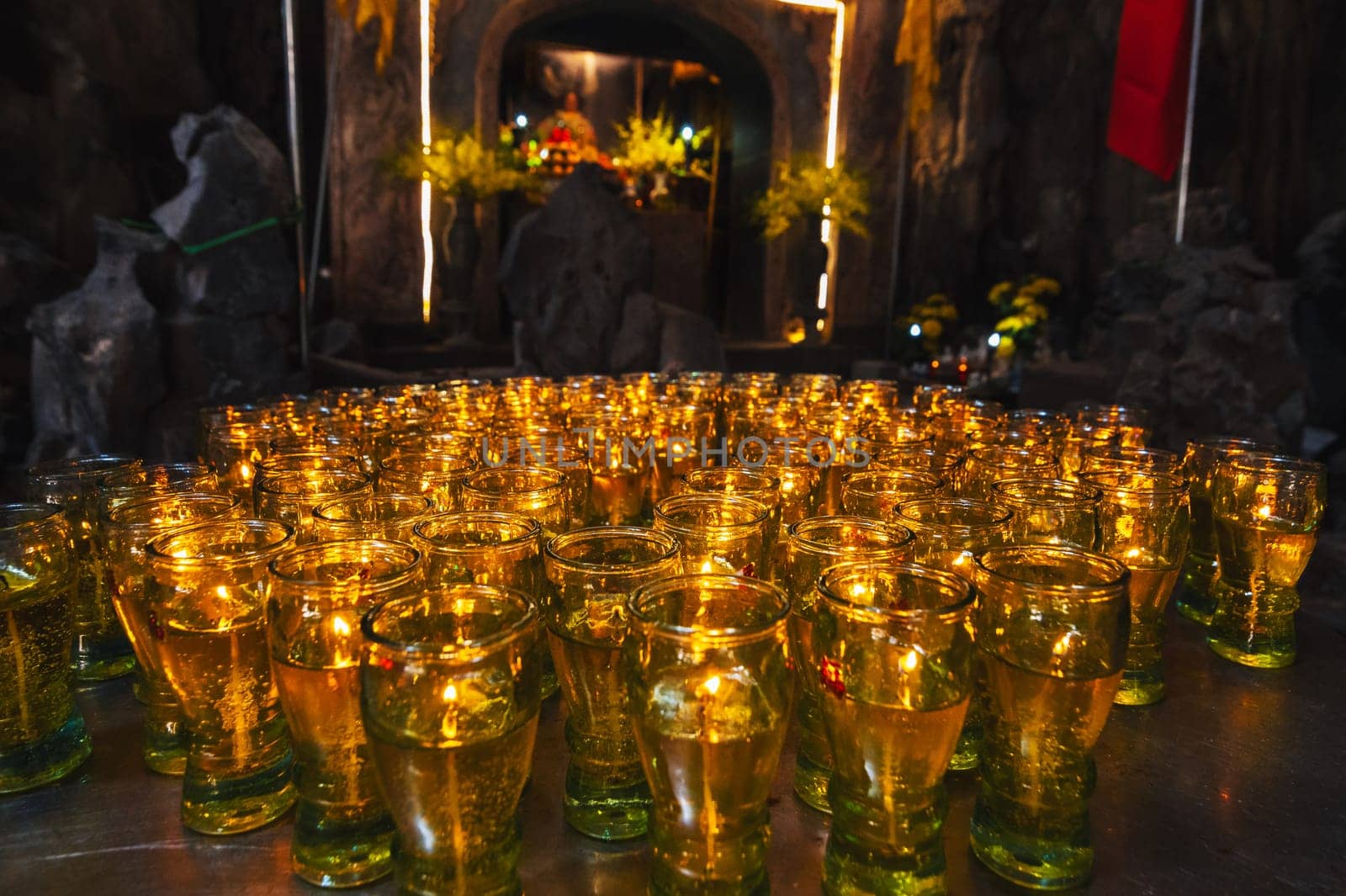 A row of candles placed in a glass in the temple.