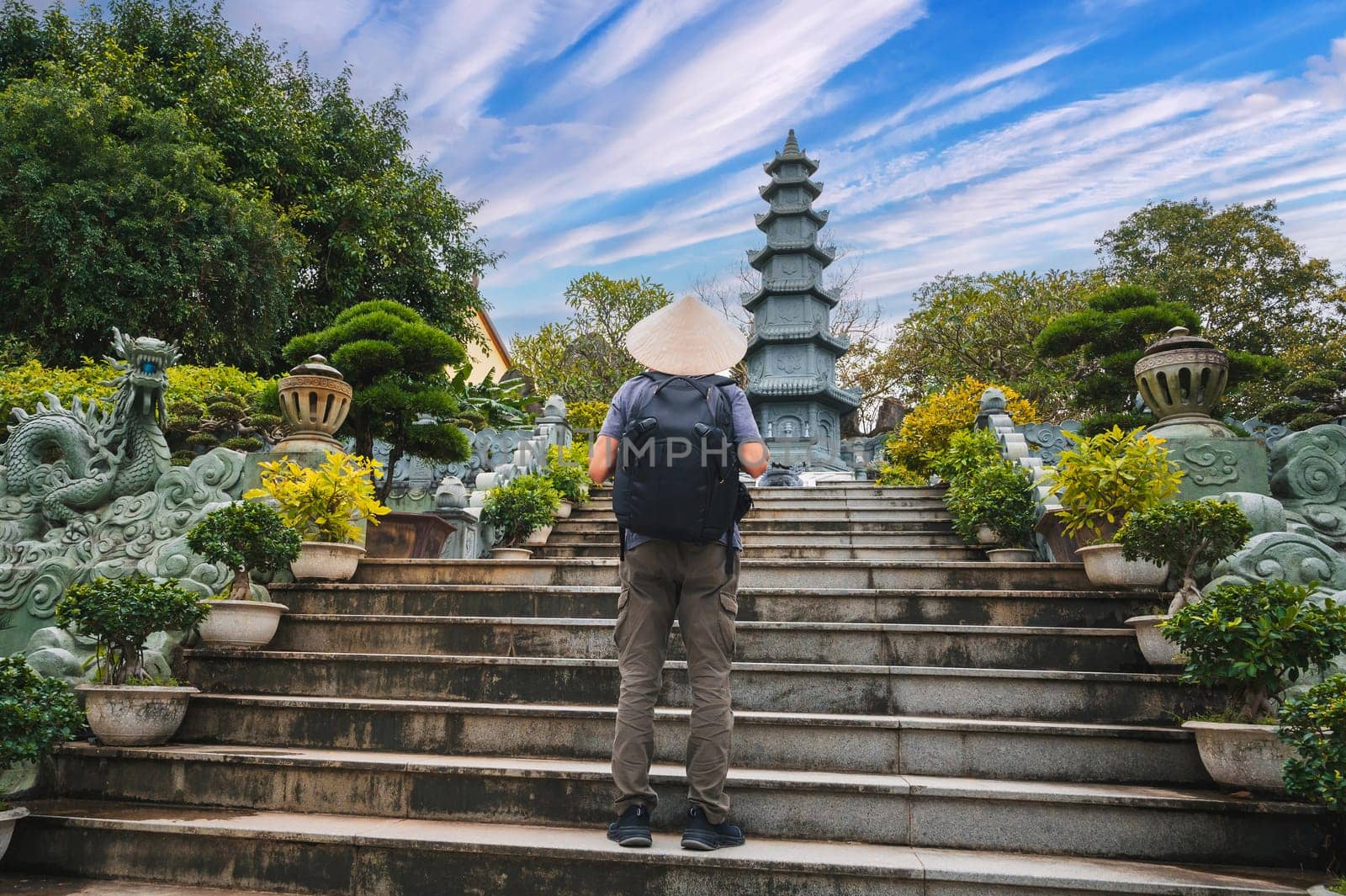 back of a male tourist traveler at the Linh Ung Pagoda in Da Nang in Vietnam. Concept of travel and tourism in Asia