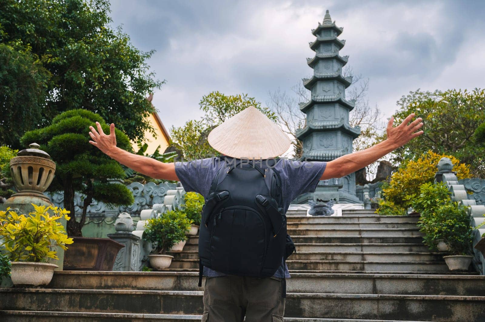 back of a male tourist traveler at the Linh Ung Pagoda in Da Nang in Vietnam. The concept of travel and tourism in Asia