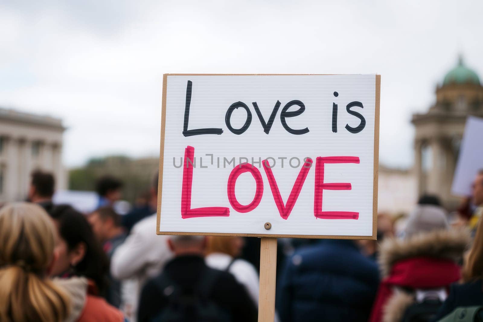 A close-up of the “Love is Love” poster at a public meeting