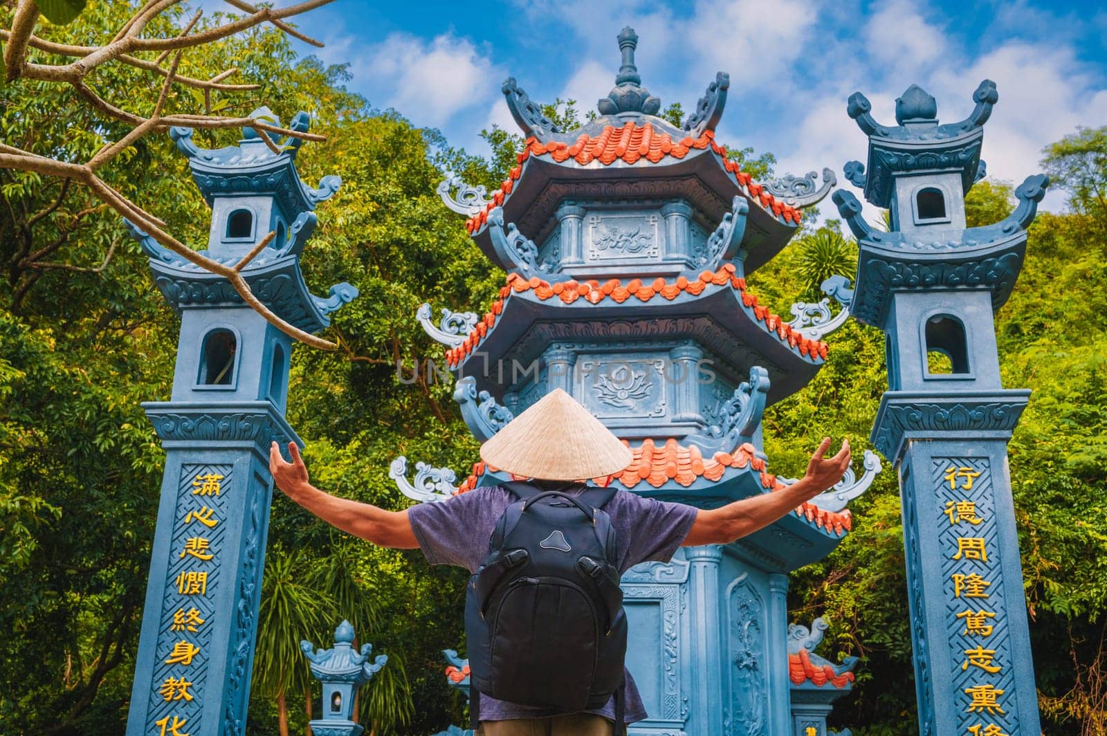 back of a man tourist traveler at the temple on Buddhist pagoda in Da Nang, Vietnam. Travel and tourism in Asia