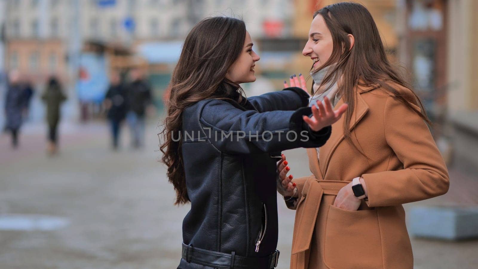 Two best friends meet on the streets of the city and hug