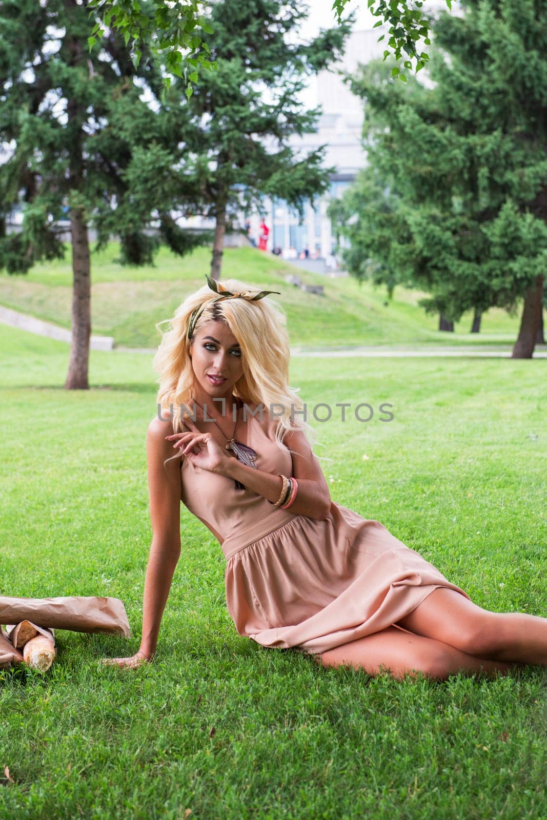Rest in park, outdoor, people and leisure concept - beauty blonde alone young woman resting in the park
