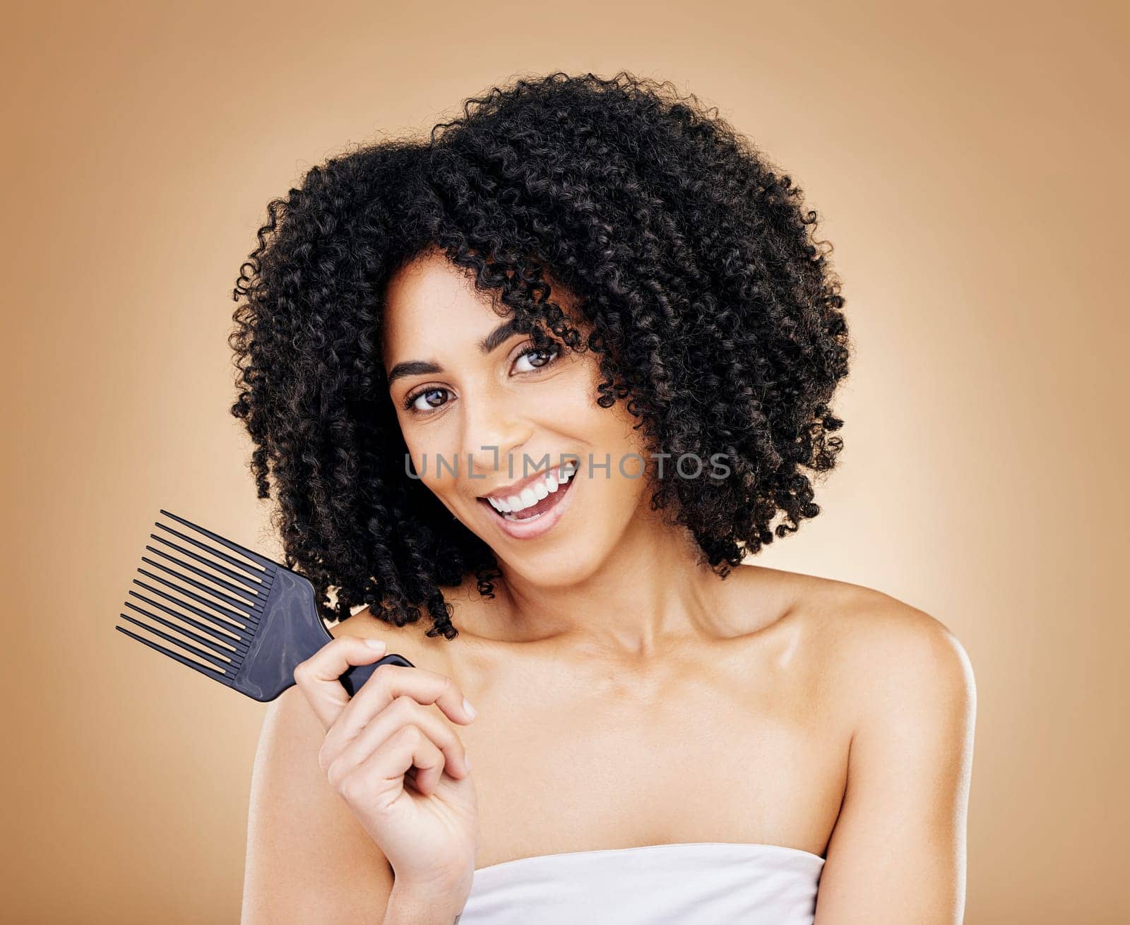 Hair, curls and woman with comb, beauty and treatment for shine, cosmetic care and portrait on studio background. Wellness, haircare and growth with strong texture and brush locks, volume and afro.