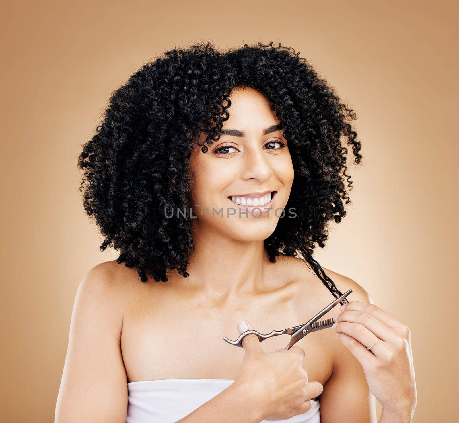 Hair, scissors with curls and portrait of woman, beauty and cosmetic care and change on studio brown background. Wellness, haircare and haircut with strong texture and cut locks, volume and afro by YuriArcurs