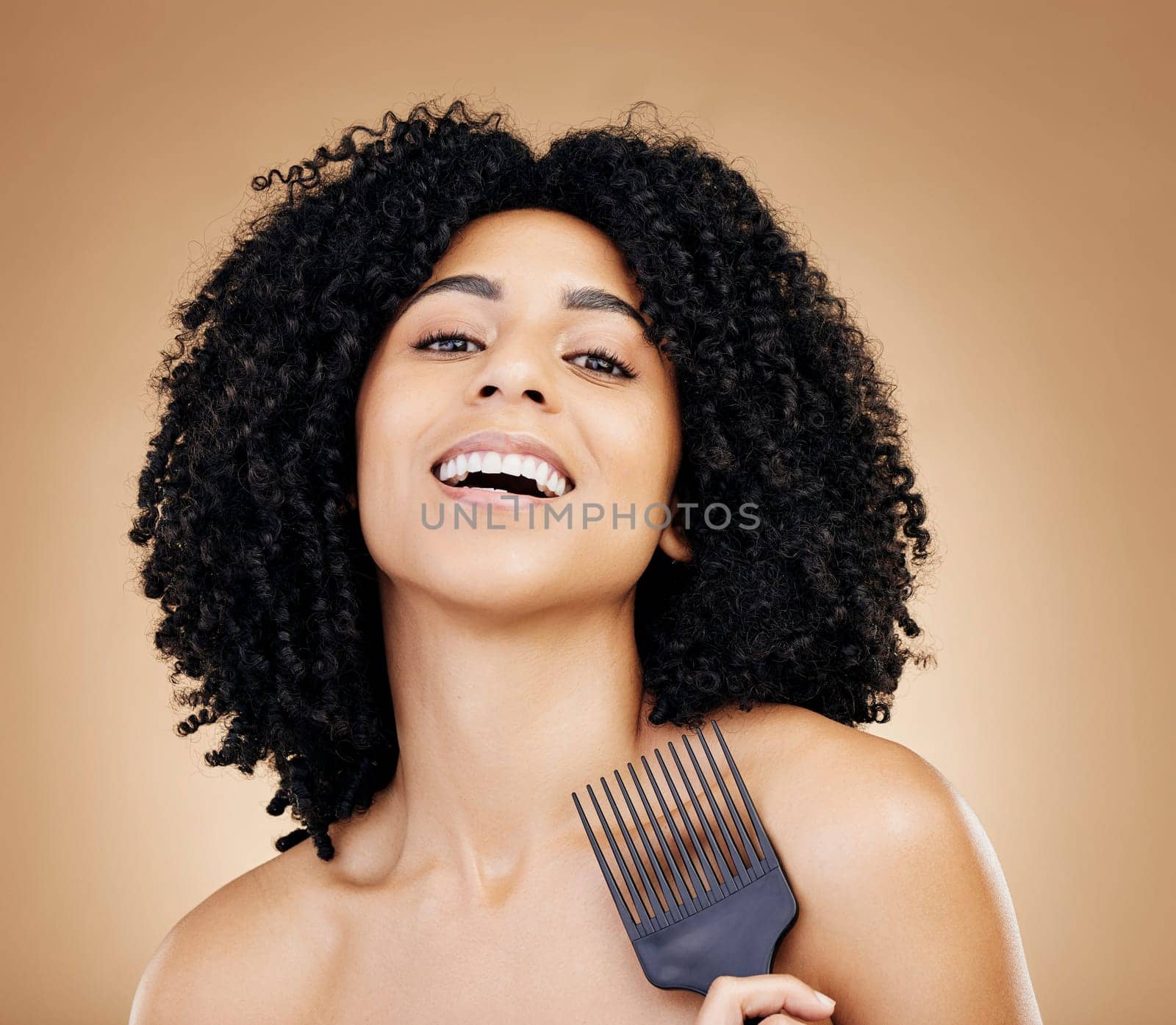 Portrait, hair care and woman with a comb, afro and salon treatment with volume on brown background. Face, person or model with grooming, shine or glow with beauty, texture or aesthetic with keratin by YuriArcurs