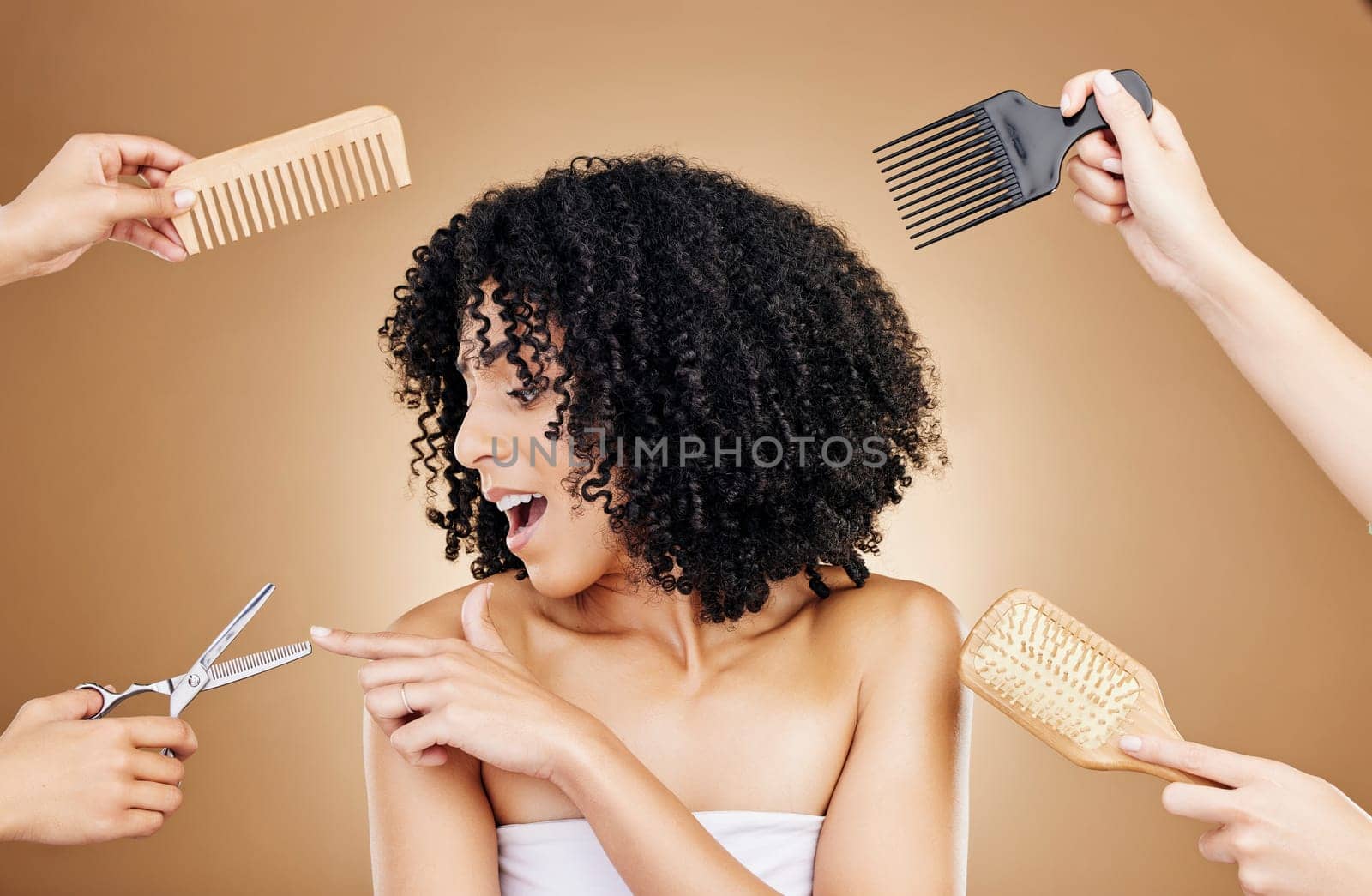 Hair care, shock and tools of woman in a studio with curly, natural and salon treatment. Smile, beauty and model from Mexico with scissor, brush and comb for hairstyle isolated by brown background by YuriArcurs