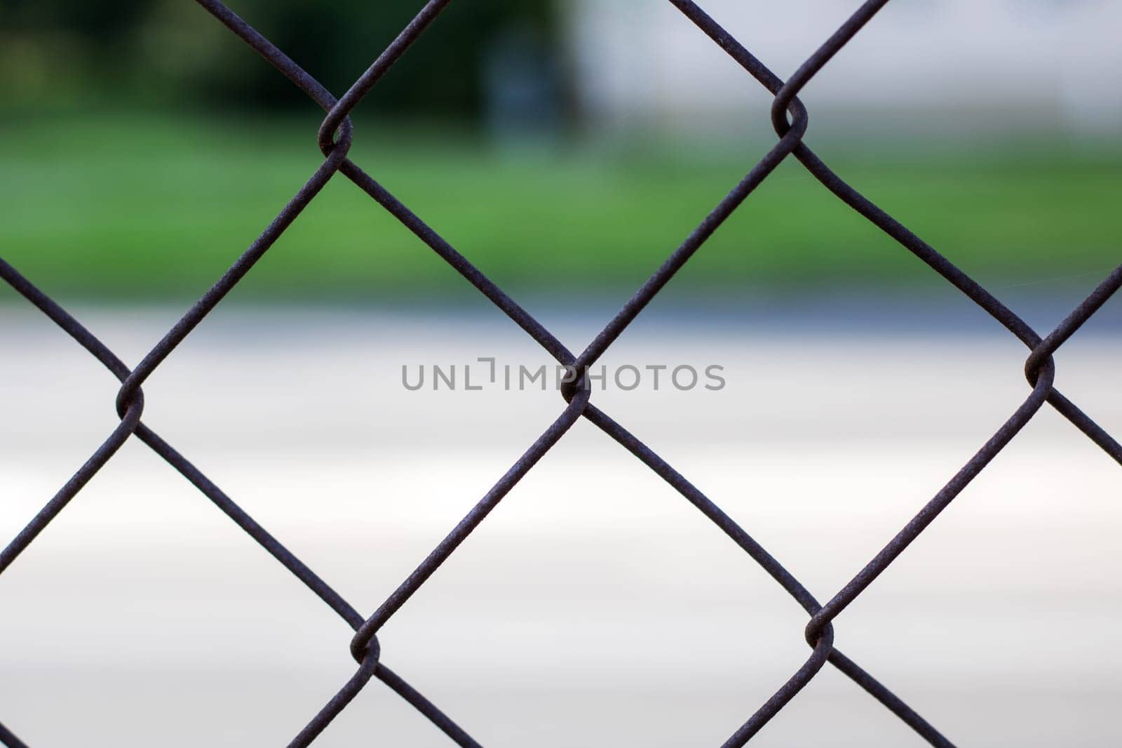 Metal mesh on the background of the road close up