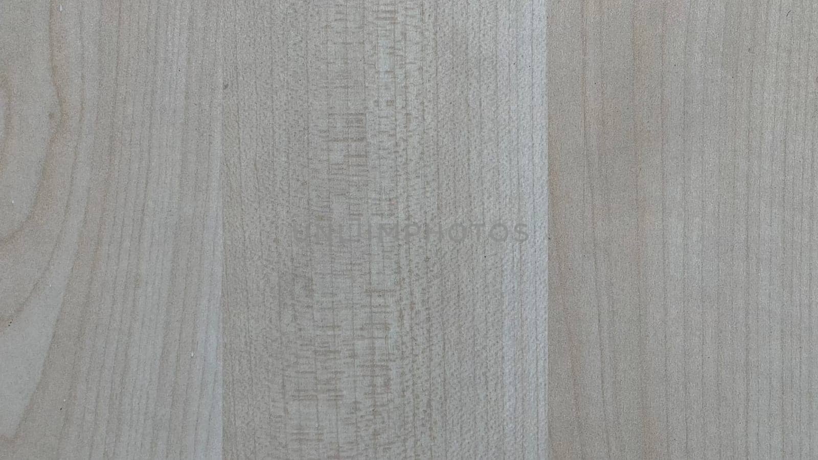 A close view of a light-colored wooden surface showcasing unique grain patterns.