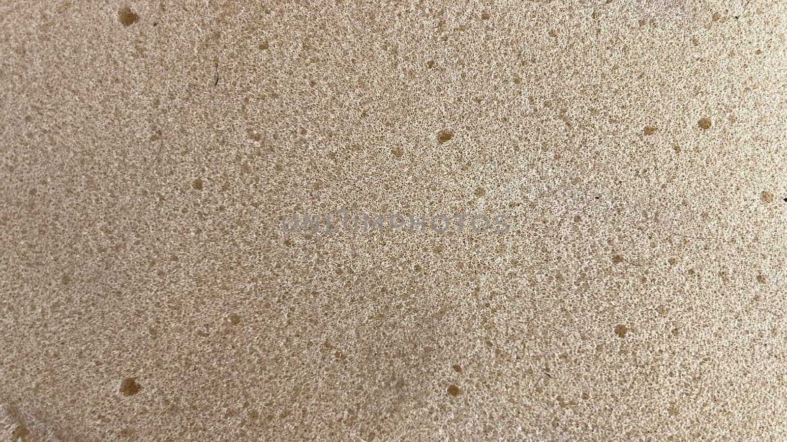 Freshly made bread dough rests on a flat surface before baking, showing its soft, airy texture.
