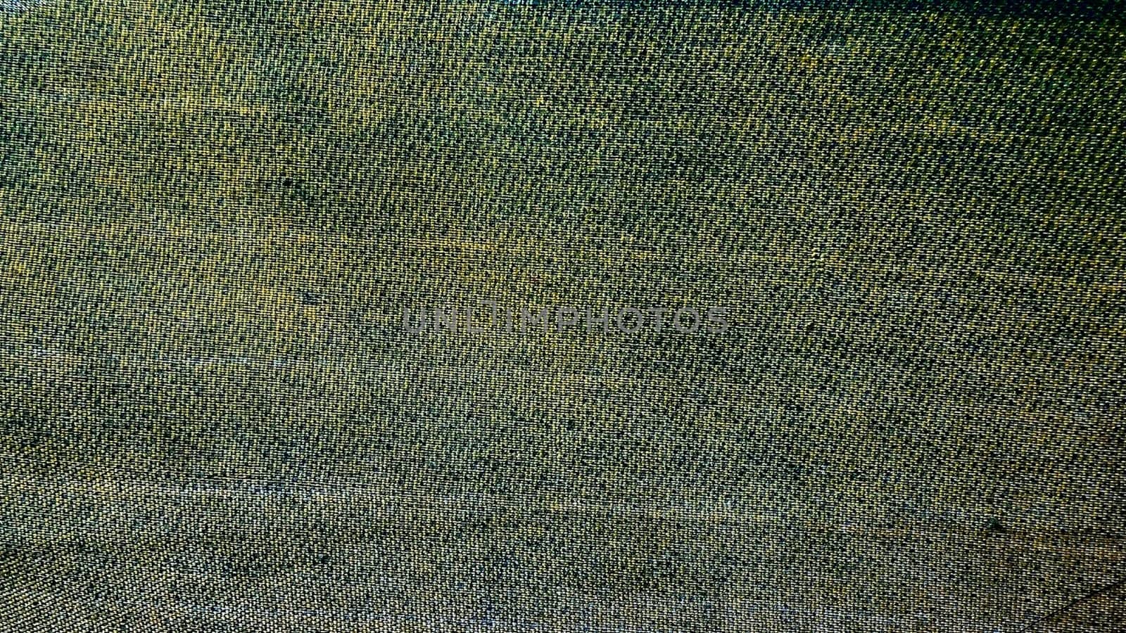 Close-up of textured fabric showcasing a blend of green and brown hues.