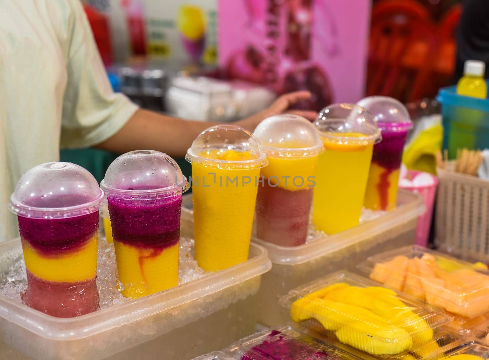 Many smoothie and drinks in plastic cups in Jalan Alor street food in the Kuala Lumpur market
