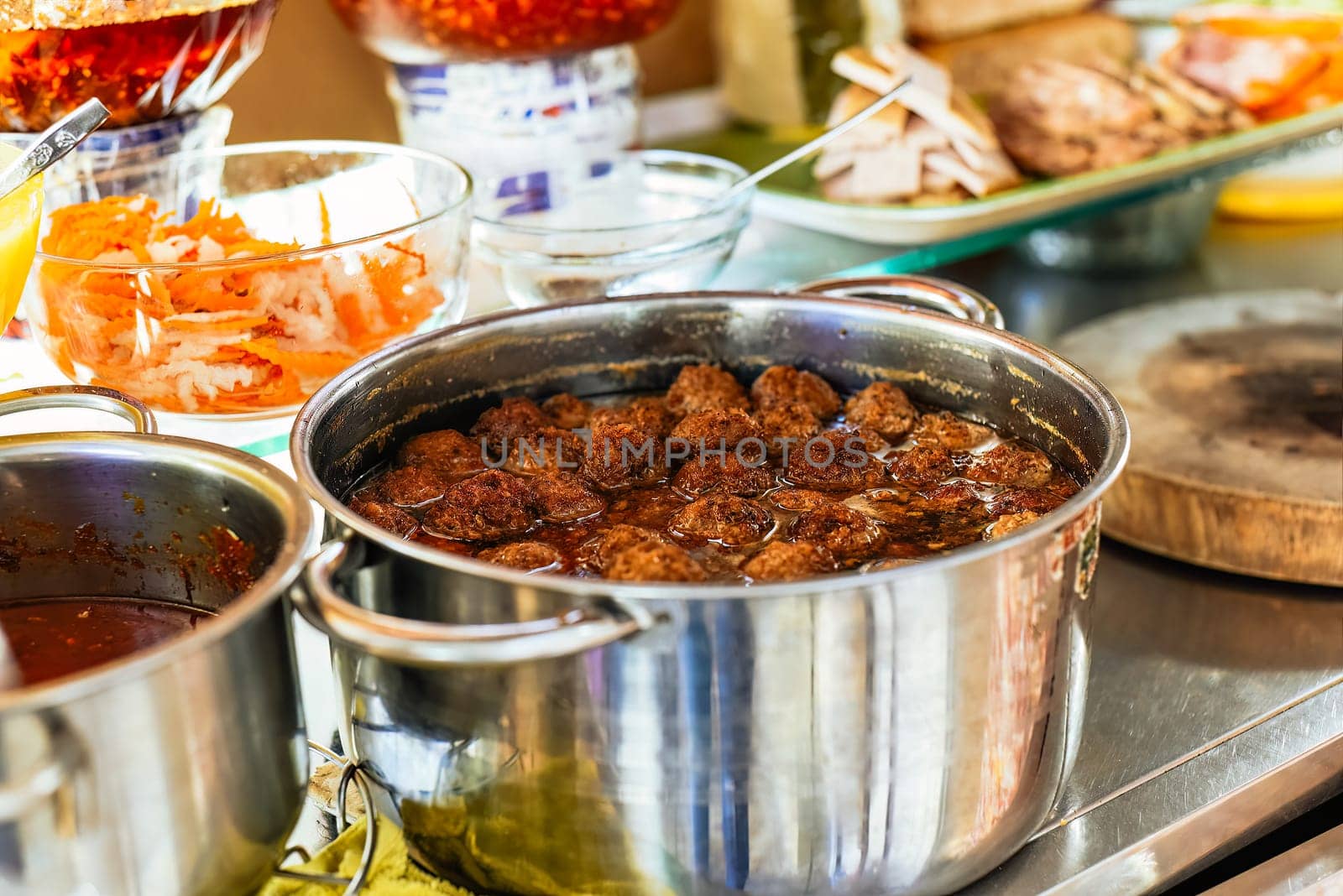 meatballs in asian sauce in a pot on street food in Vietnam
