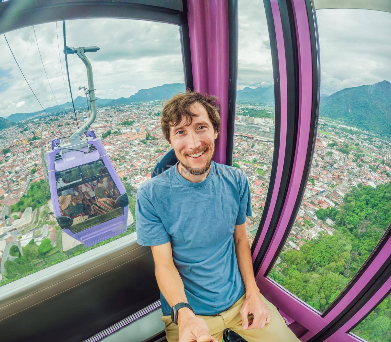 Male tourist riding a cable car in Orizaba, Mexico. Scenic aerial journey with breathtaking mountain and city views. Concept of adventure, eco-tourism, and exploration of Mexican landscapes.