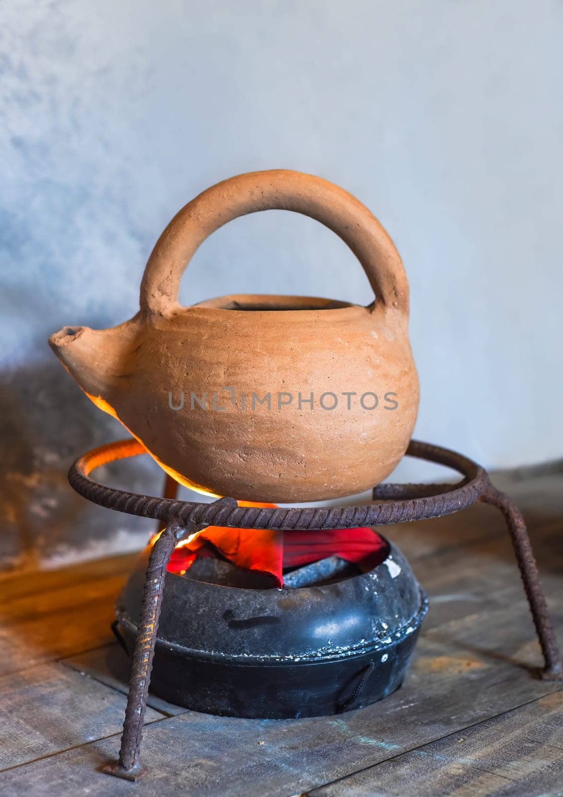 Clay teapot on artificial hearth