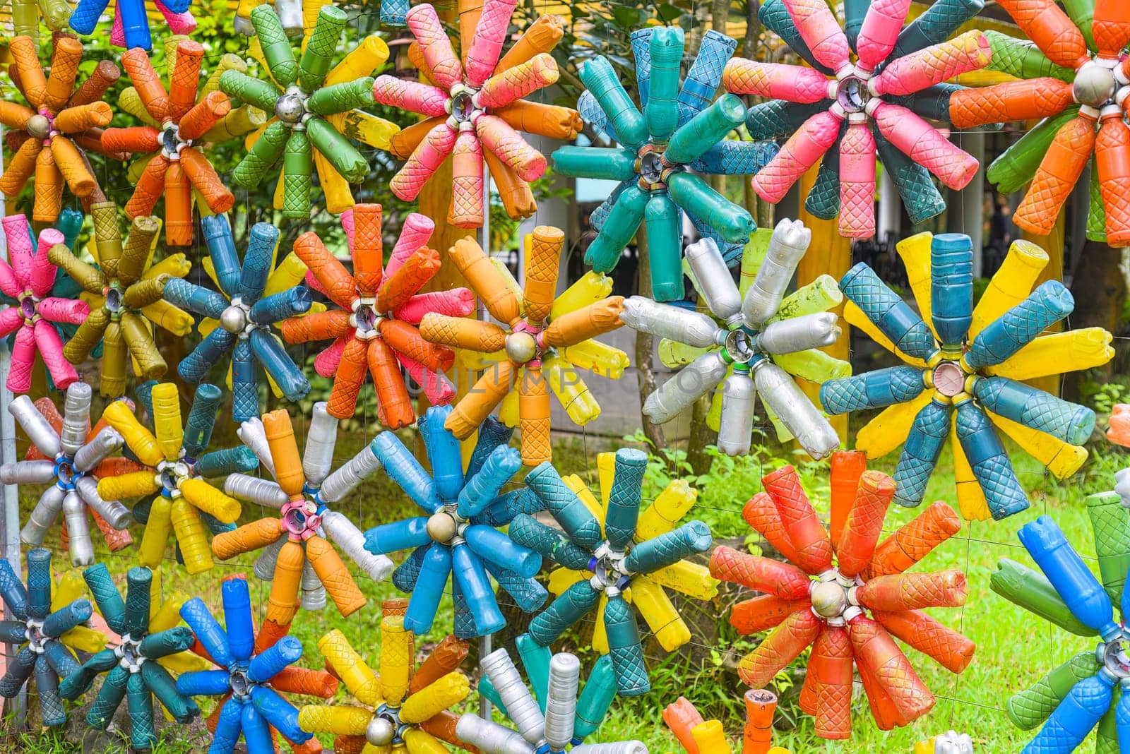 Flower shaped colourful decorations made of plastic bottles