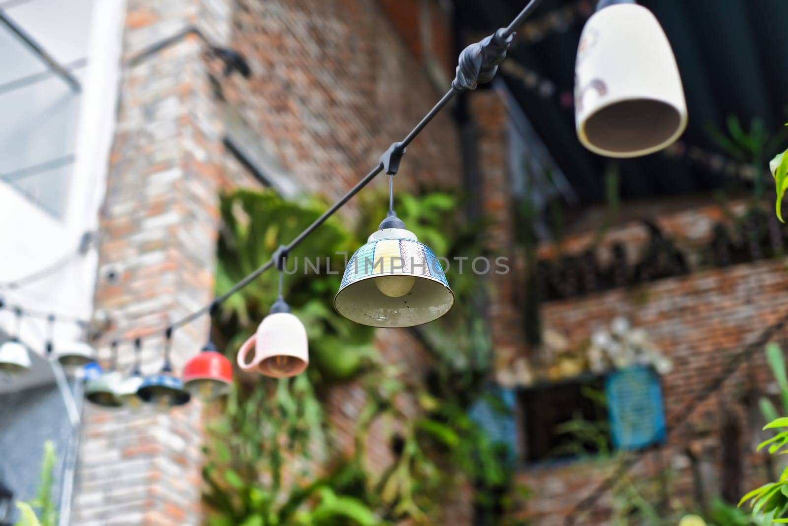 Creative design for garden: many old glass dishes with lights garland