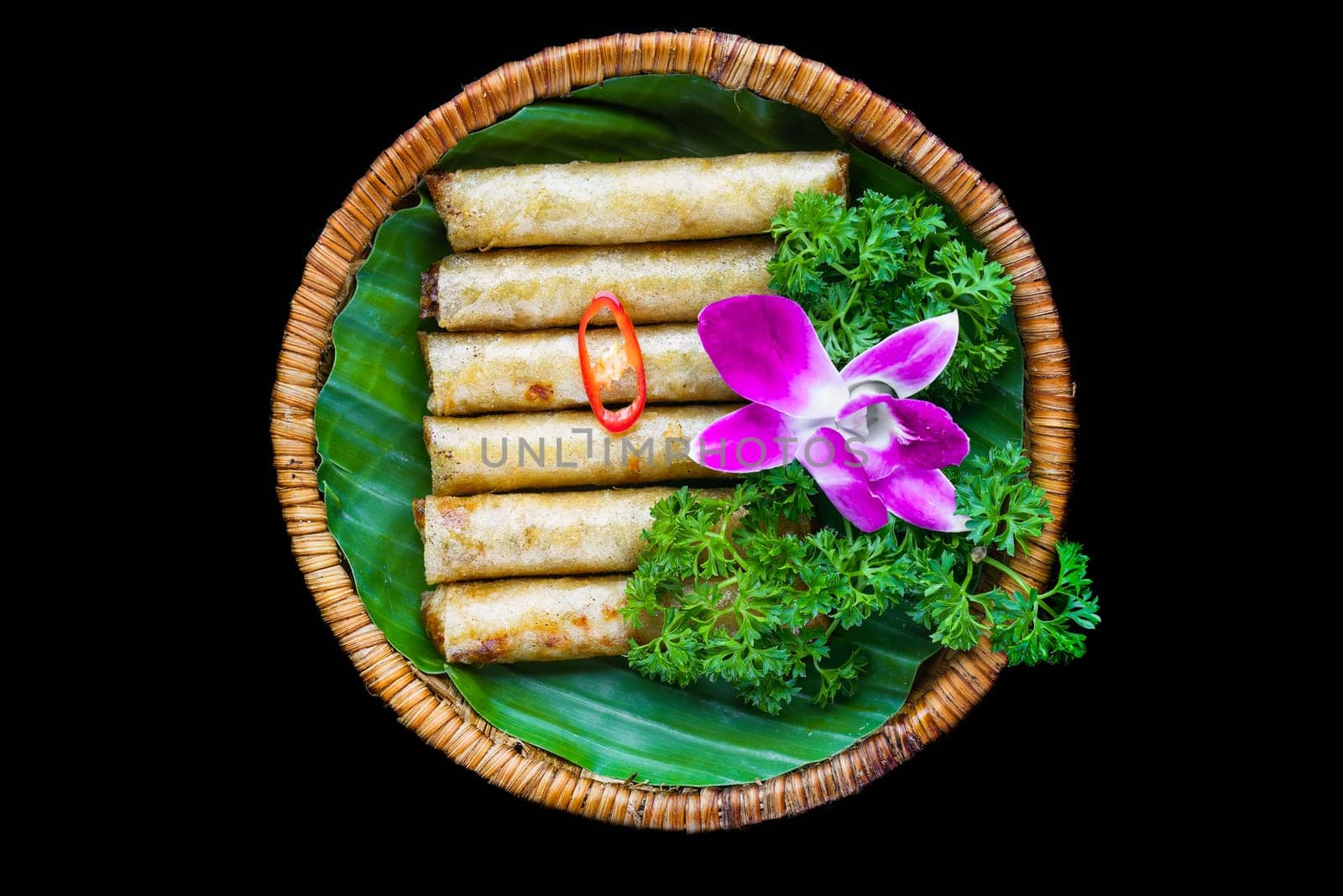 Traditional fried vietnamese spring rolls with pork, rice paper on black background side view