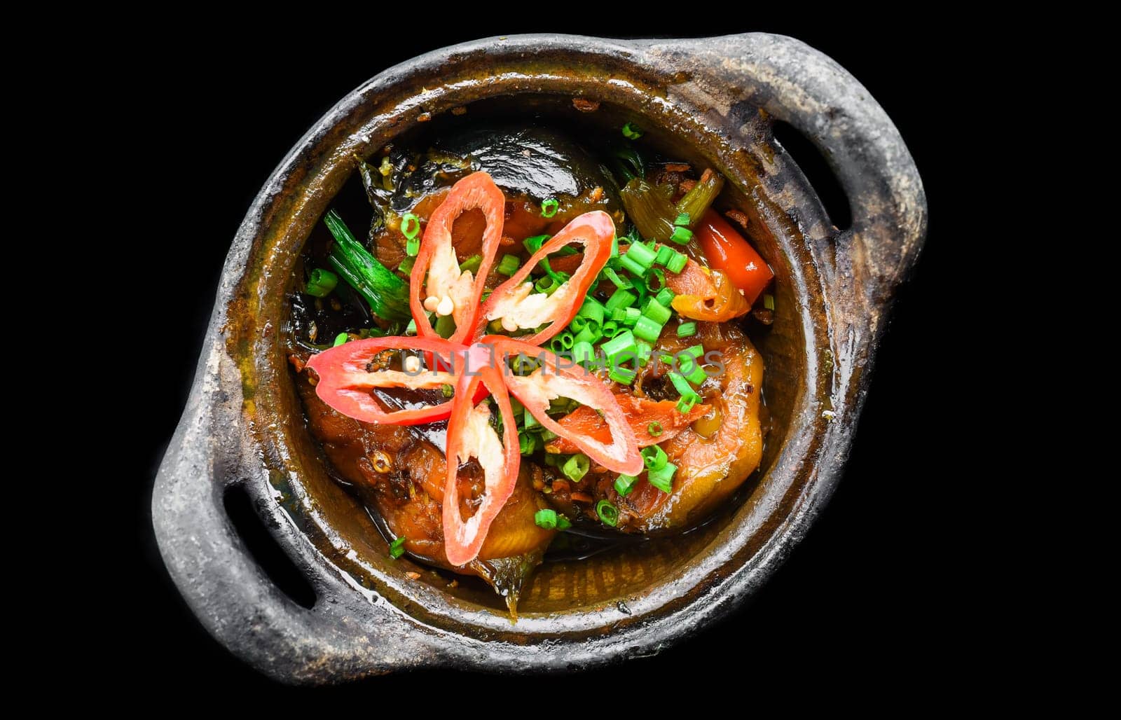 Vietnamese fried Mackerel fish with sauce on black background