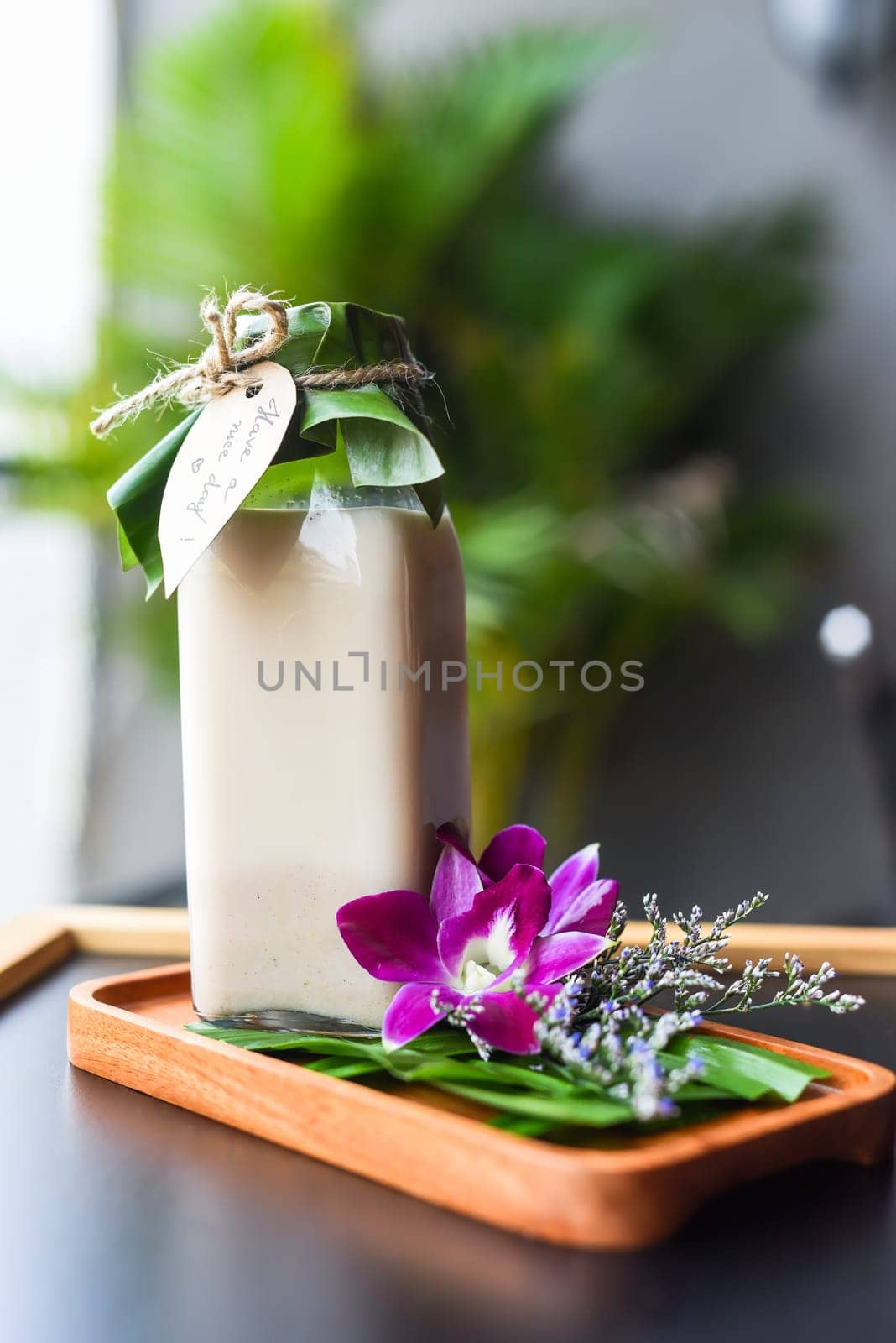 Yogurt with flowers and sign Have a nice day isolated on black background