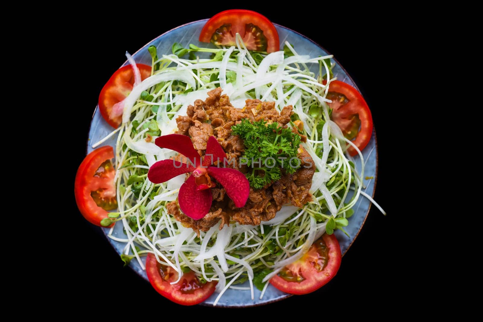 Vietnamese fried beef with salad and sauce on black background for a menu