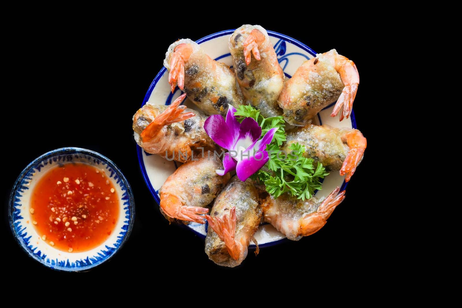 Traditional fried vietnamese spring rolls with shrimps and pork, rice paper on black background