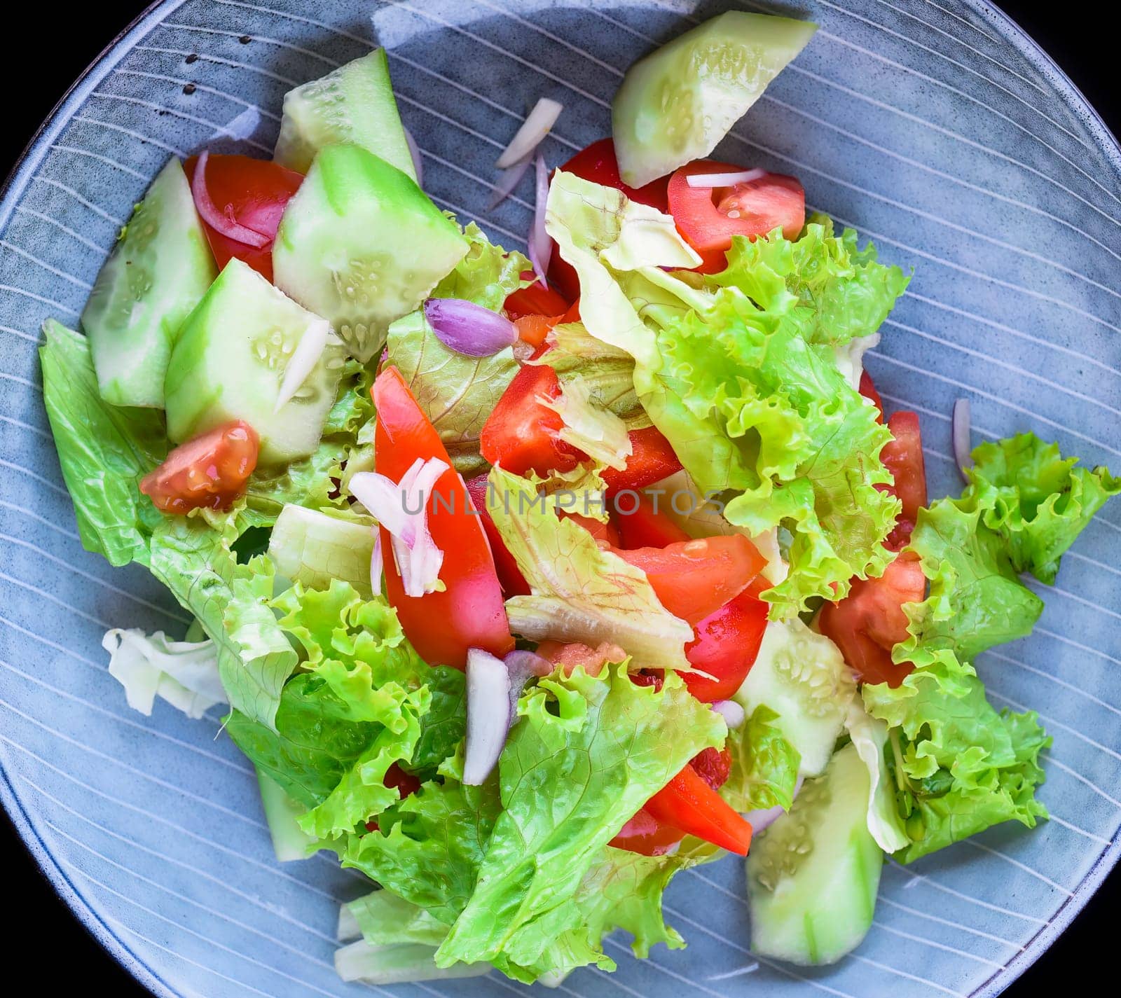 Fresh Vietnamese salad with vegetables on black background side view
