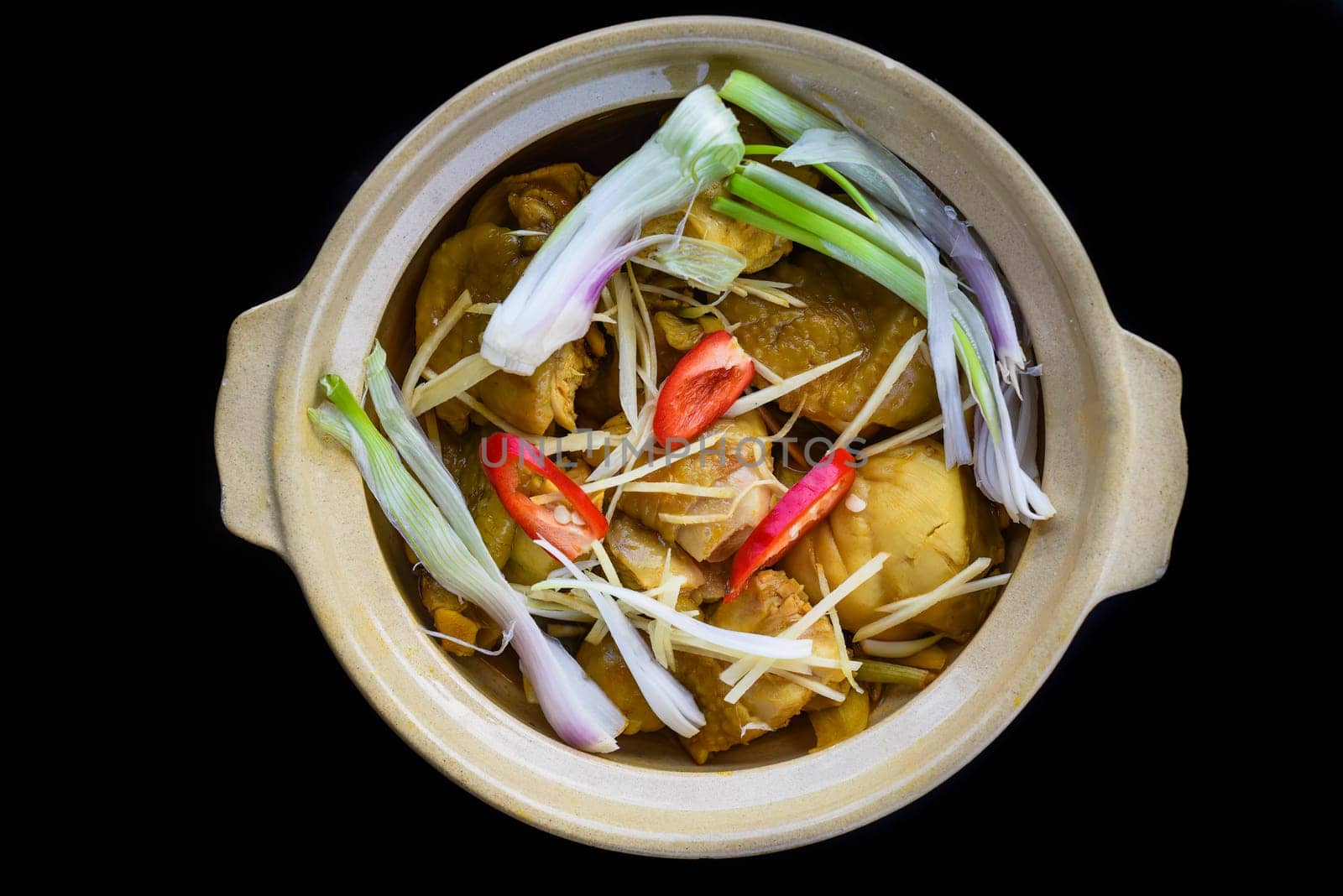 Vietnamese fried chicken thighs with onion isolated on black background top view