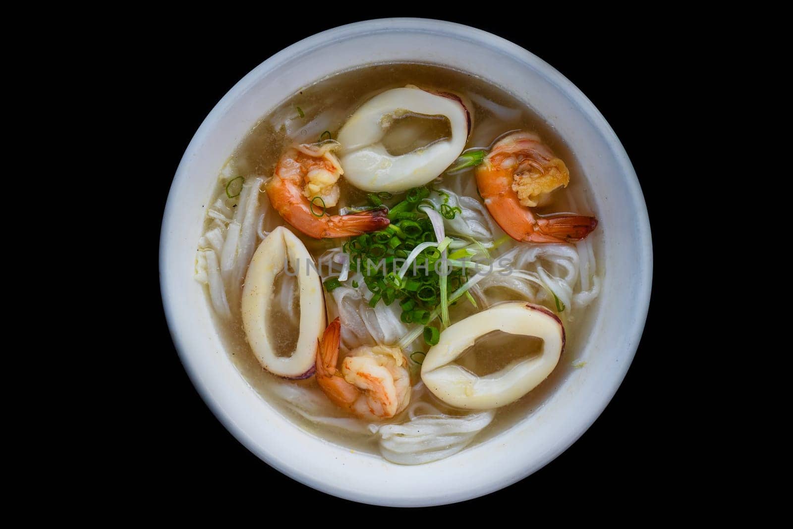 Traditional vietnamese soup Pho with seafood on black background