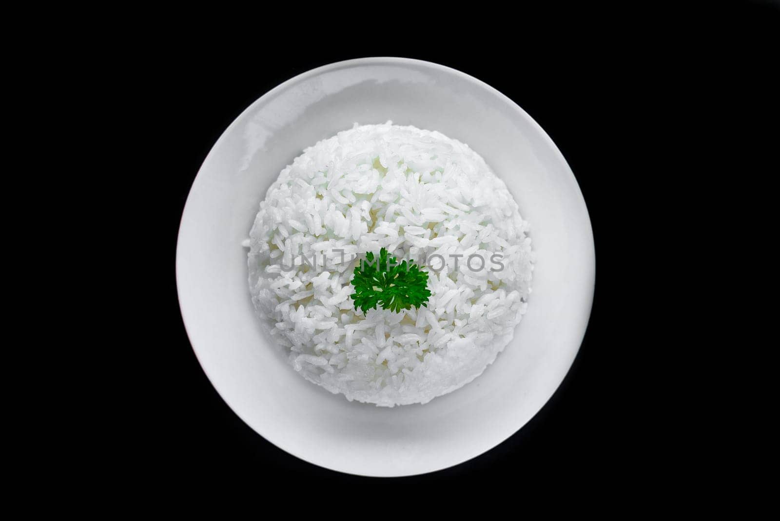 Plate with white rice, serving for Vietnamese dishes on black background